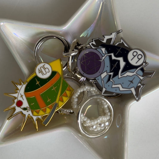 Star-shaped dish with various colorful charms on a white background